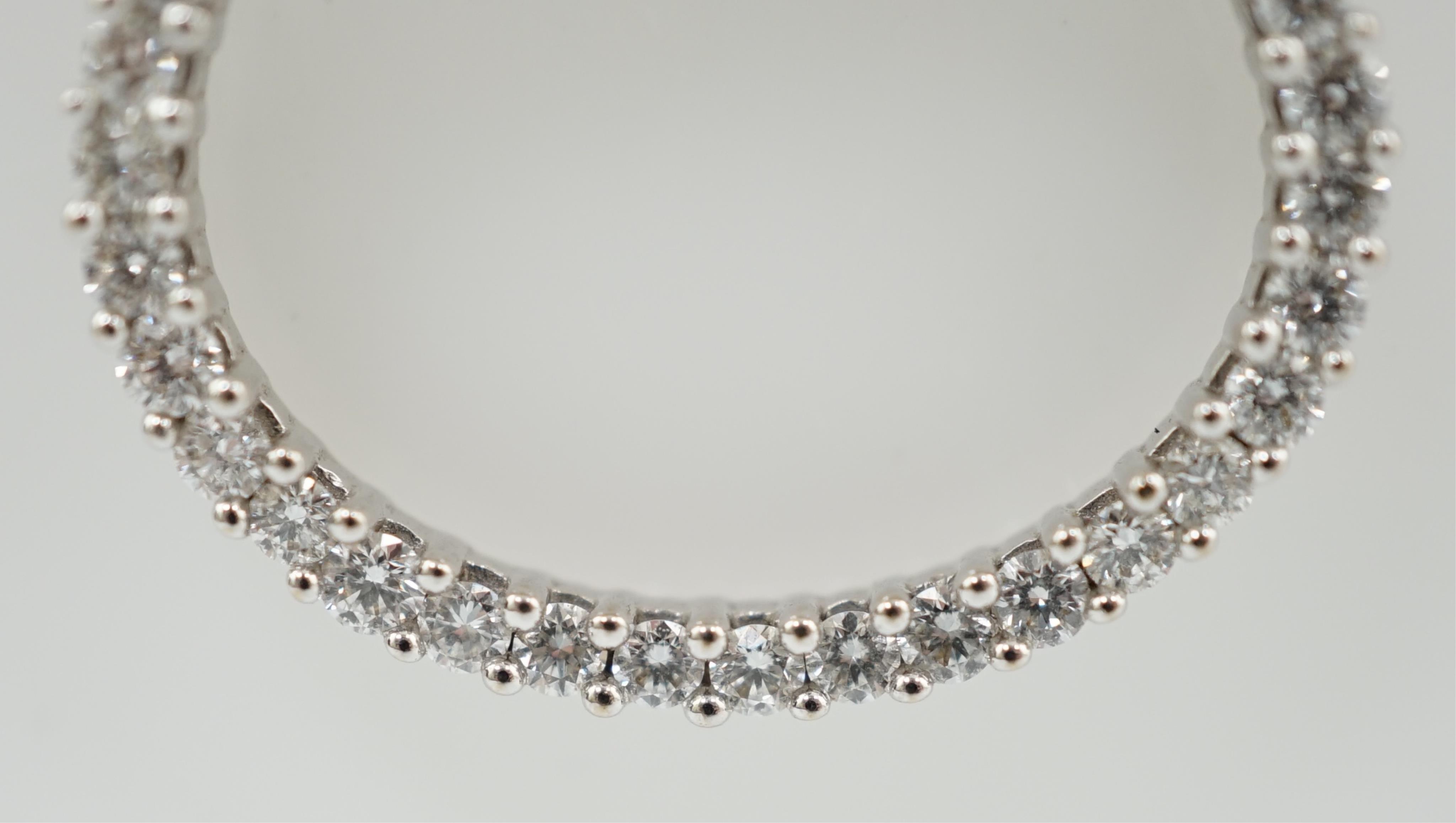 A modern 18k white gold and diamond cluster set open work oval pendant, on an Italian 18k white gold fine link chain